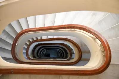 a spiral staircase in a building at Aura Suite Stadiou by Zeus Suites in Athens