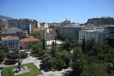 a view of a city with a statue in a park at Aura Suite Stadiou by Zeus Suites in Athens