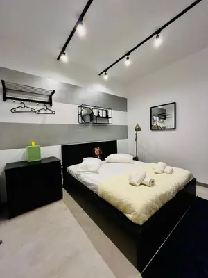 a bedroom with a large bed and a bench at Poseidon Suite Korai by Zeus Suites in Athens