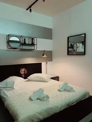 a bedroom with a bed with two towels on it at Poseidon Suite Korai by Zeus Suites in Athens