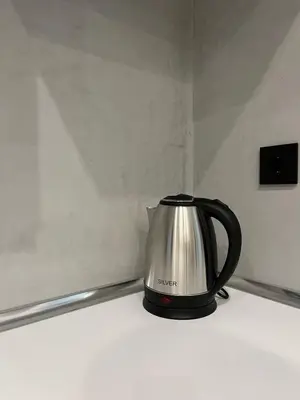 a black and silver tea kettle sitting on a counter at Poseidon Suite Korai by Zeus Suites in Athens