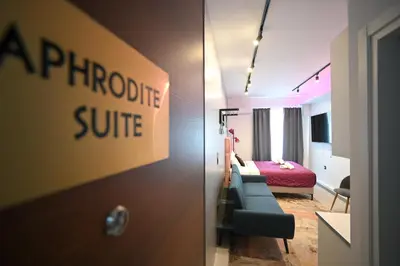 a hotel room with a couch and a bedroom at Aphrodite Suite Klathmonos by Zeus Suites in Athens