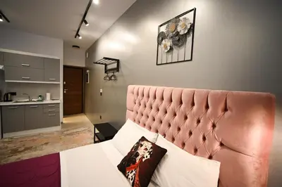 a bedroom with a bed with a red head board at Aphrodite Suite Klathmonos by Zeus Suites in Athens