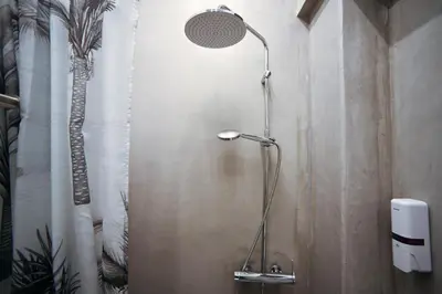 a shower with a shower head in a bathroom at Aphrodite Suite Klathmonos by Zeus Suites in Athens