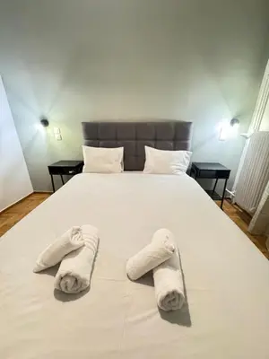 a bedroom with a bed with towels on it at Athens City Themis 1 in Athens