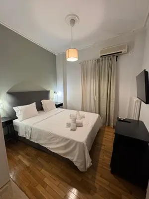 a bedroom with a white bed with towels on it at Athens City Themis 1 in Athens