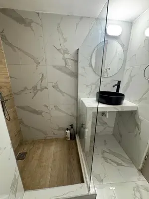 a bathroom with a shower with a glass door at Athens City Themis 1 in Athens