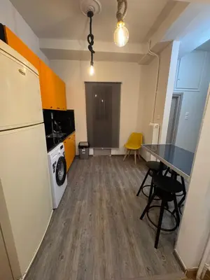 a kitchen with a refrigerator and a table and a washer at Athens City Themis 1 in Athens