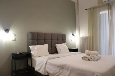 a bedroom with a large bed with two towels on it at Athens City Themis 1 in Athens
