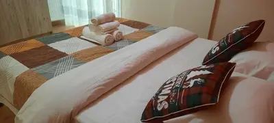 a bed with a quilt and pillows on it at NewRoom2AmbelokipiMetroAirportLine in Athens