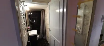 a small bathroom with a toilet and a bathroom door at NewRoom2AmbelokipiMetroAirportLine in Athens