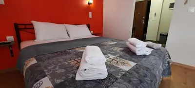 a bedroom with a bed with towels on it at NewRoom2AmbelokipiMetroAirportLine in Athens