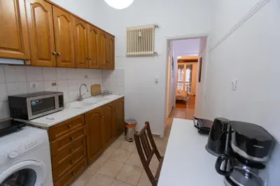 a kitchen with a sink and a washer and dryer at Near Acropolis, Koukaki Retreat in Athens