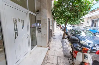 a street with cars parked next to a building at Near Acropolis, Koukaki Retreat in Athens