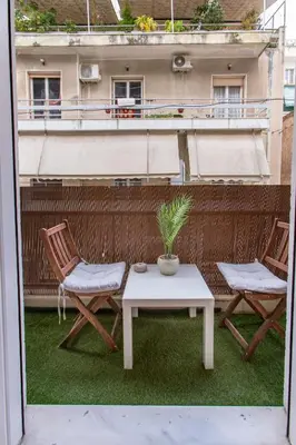 a patio with two chairs and a table with a plant at Near Acropolis, Koukaki Retreat in Athens