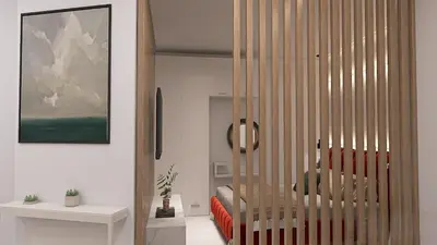a living room with a red couch and a crib at Cozy and Modern Flat in Athens