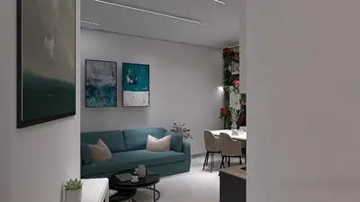 a living room with a blue couch and a table at Cozy and Modern Flat in Athens