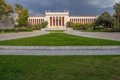 a building with a road leading into a park at Museum District Apartment in Athens