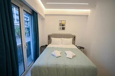 a bedroom with a bed with two towels on it at Artemis Patision Suite by Zeus Suites in Athens