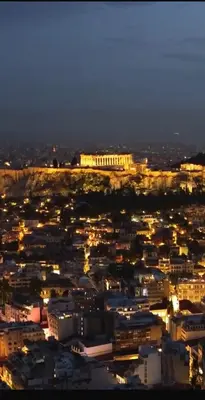 a view of a city at night with lights at Artemis Patision Suite by Zeus Suites in Athens