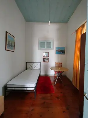 a bedroom with a bed and a table at Sunny apartment next to the Acropolis in Athens