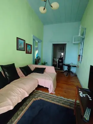 a bedroom with two beds and a living room at Sunny apartment next to the Acropolis in Athens