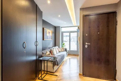 a living room with a couch and a sliding door at Athens Horizon Views Apartment in Athens