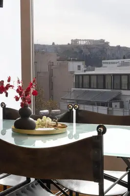 a table with a plate of food on top of a window at Athens Horizon Views Apartment in Athens