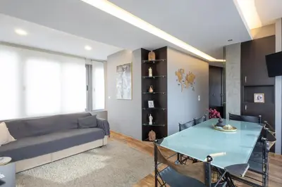 a living room with a couch and a table at Athens Horizon Views Apartment in Athens
