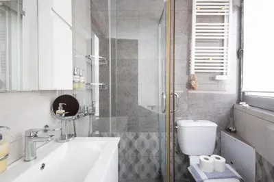 a bathroom with a toilet and a sink and a shower at Athens Horizon Views Apartment in Athens