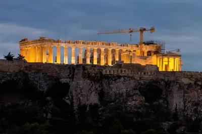 a building on top of a hill with a crane at Athens Horizon Views Apartment in Athens