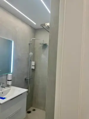 a bathroom with a shower and a sink at Apollon Patision Family Suite by Zeus Suites in Athens