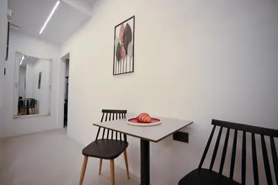 a dining room with a table and two chairs at Apollon Patision Family Suite by Zeus Suites in Athens
