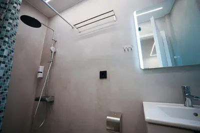 a bathroom with a shower and a sink and a mirror at Apollon Patision Family Suite by Zeus Suites in Athens