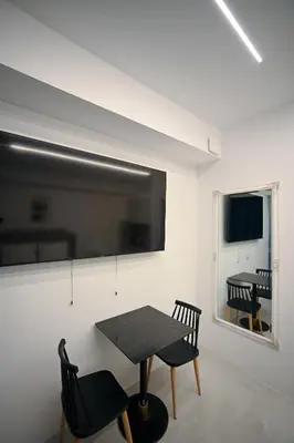 a dining room with a table and chairs and a window at Erato Pedion Areos Suite by Zeus Suites in Athens