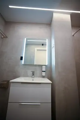 a bathroom with a sink and a mirror at Erato Pedion Areos Suite by Zeus Suites in Athens