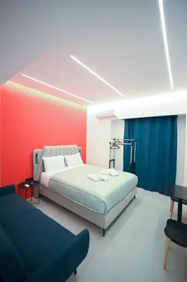 a bedroom with a bed and a couch at Museum Pedion Areos Family Suite by Zeus Suites in Athens