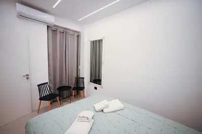 a bedroom with a bed with two towels on it at Museum Pedion Areos Family Suite by Zeus Suites in Athens