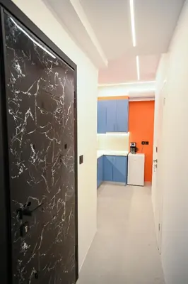 a door in a room with a kitchen at Museum Pedion Areos Family Suite by Zeus Suites in Athens