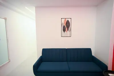 a blue couch in a room with a picture on the wall at Museum Pedion Areos Family Suite by Zeus Suites in Athens