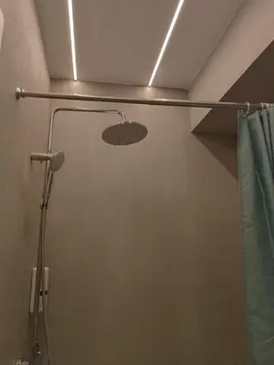 a shower in a bathroom with a shower curtain at Hera Elegant Suite by Zeus Suites in Athens