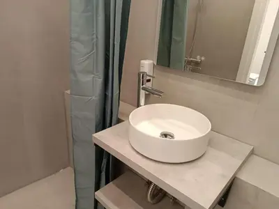 a bathroom with a white sink and a shower at Zeus Elegant Suite by Zeus Suites in Athens