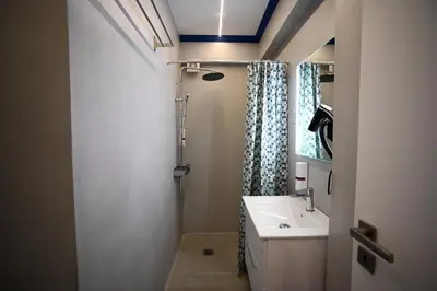 a bathroom with a sink and a mirror at Family Zeus elegant suite by Zeus suites in Athens