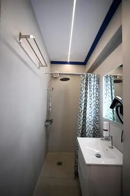 a bathroom with a sink and a mirror at Family Zeus elegant suite by Zeus suites in Athens