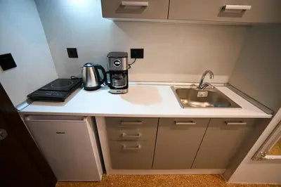 a kitchen counter with a coffee maker and a sink at Family Zeus elegant suite by Zeus suites in Athens
