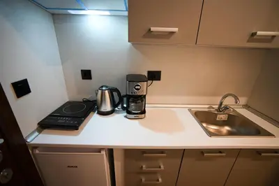 a kitchen counter with a coffee maker and a sink at Family Zeus elegant suite by Zeus suites in Athens