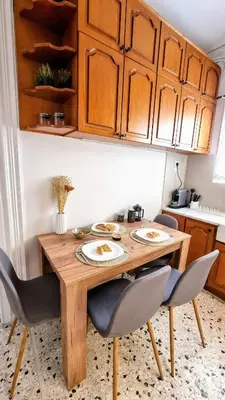 a dining room table with two chairs and a table at Mata's Athenian Mosaic - super central city stay in Athens