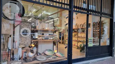 a store window with a lot of items in it at Mata's Athenian Mosaic - super central city stay in Athens