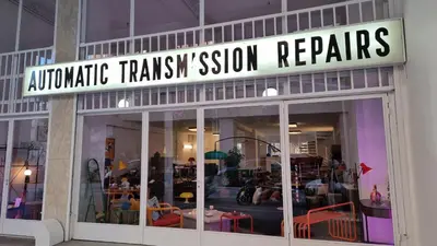 a store front with a sign that reads automatic trash session repairs at Mata's Athenian Mosaic - super central city stay in Athens