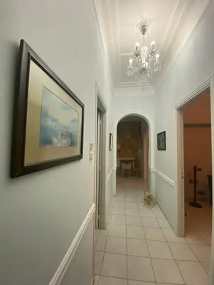 a hallway with a painting on the wall and a picture on the wall at Athens Apartment IV in Athens